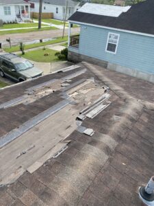 Roof storm damage inspection in Mississippi showing missing shingles and insurance claim evaluation